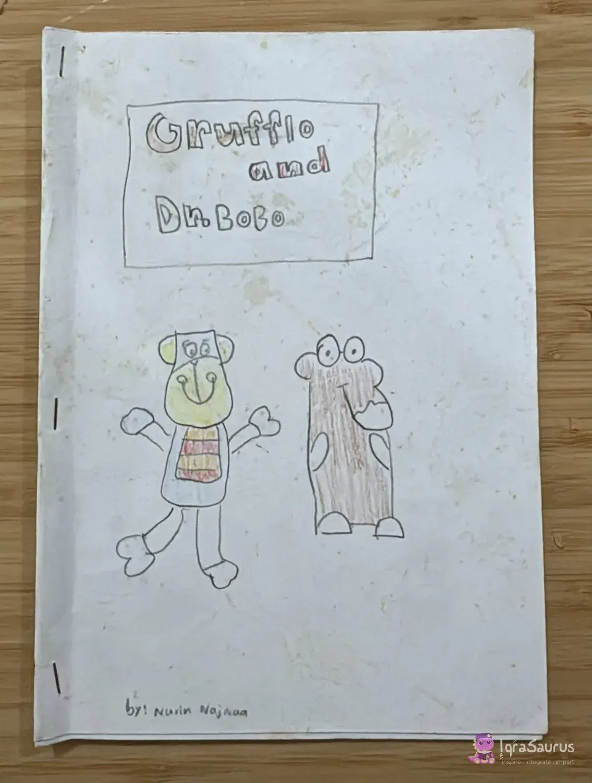 Cover with the title in a box, a teddy bear with open arms and a brown Gruffalo standing side by side.