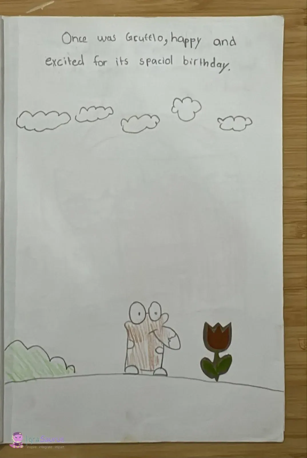 The brown Gruffalo stands on a hill between a green bush and a red tulip, under a row of clouds.